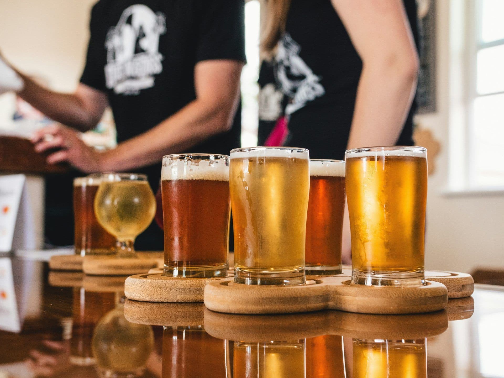Glasses of craft beer on tasting paddles at a brewery, ideal for a team building activity.