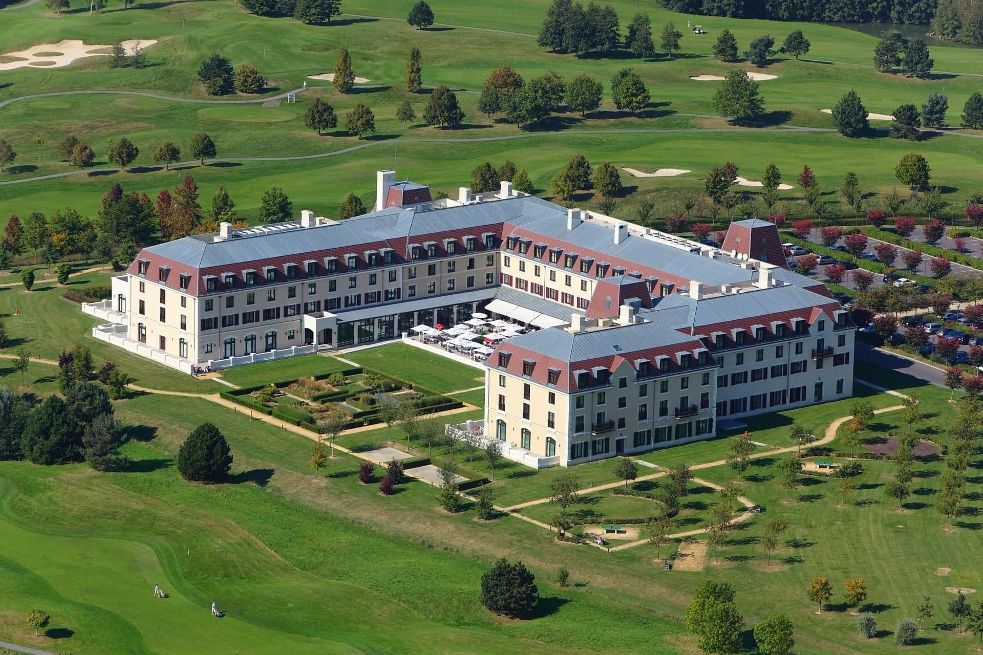 Aerial view of a large resort hotel and golf course, ideal for corporate retreats and seminars.