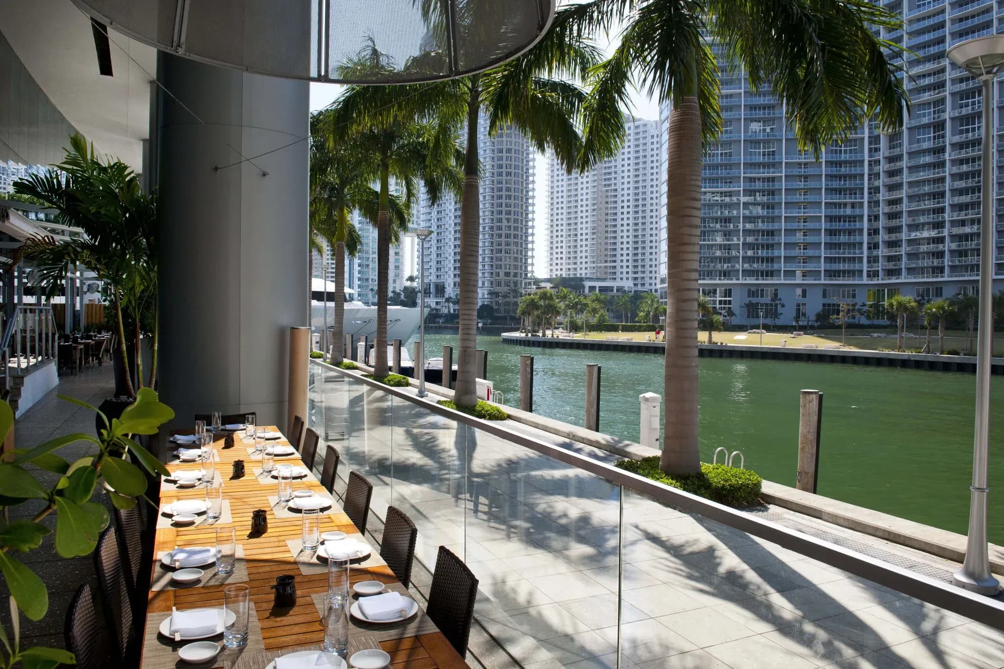 Outdoor dining terrace with a long table set for a corporate dinner