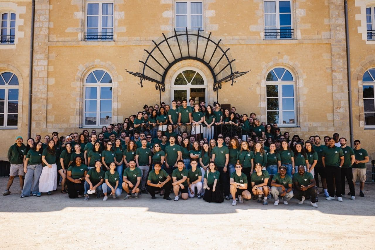 Naboo team members pose for a group photo during a corporate offsite at a historic venue.