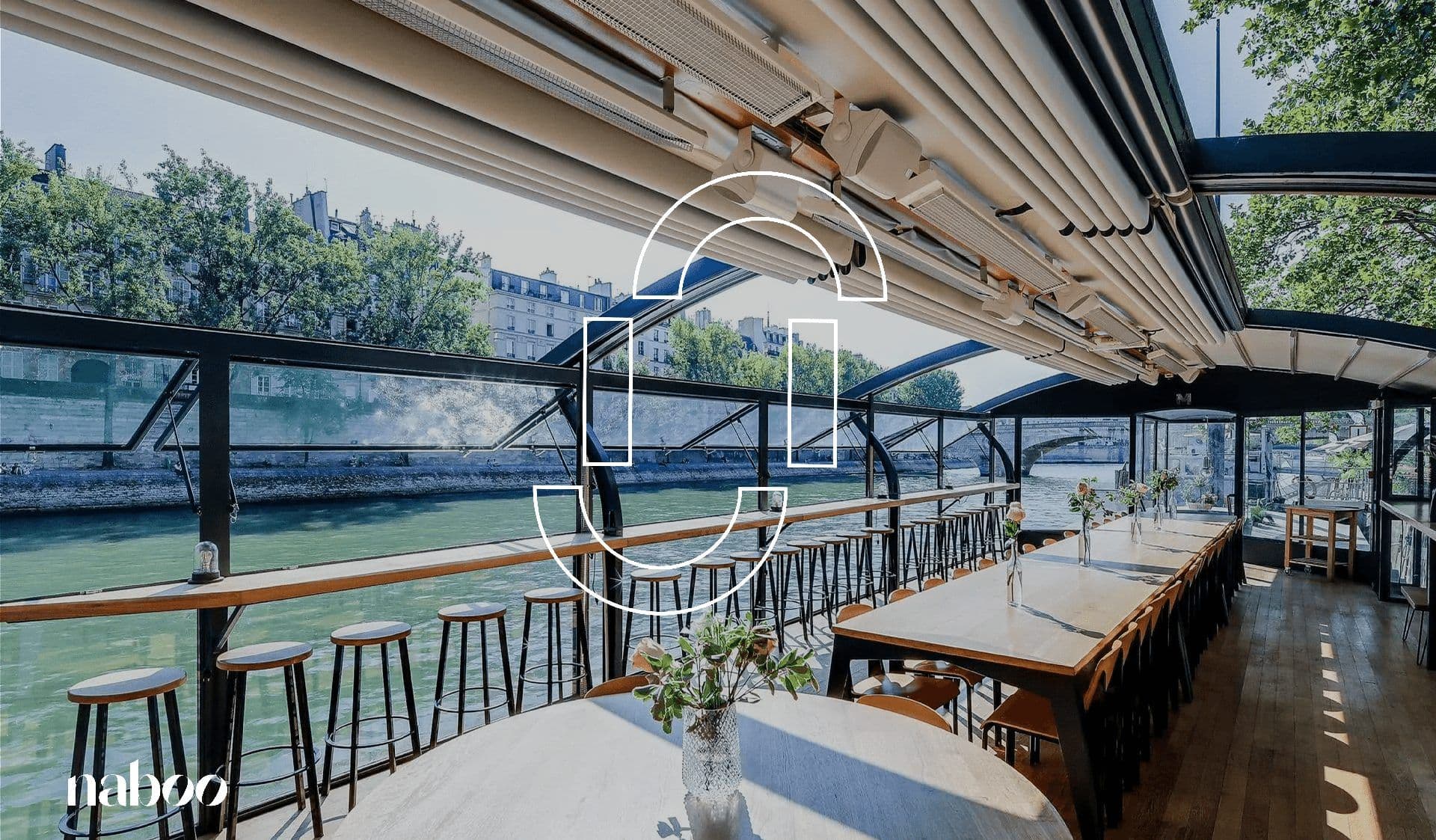 Spacious corporate event venue on a boat in Paris, featuring long tables and panoramic river views.
