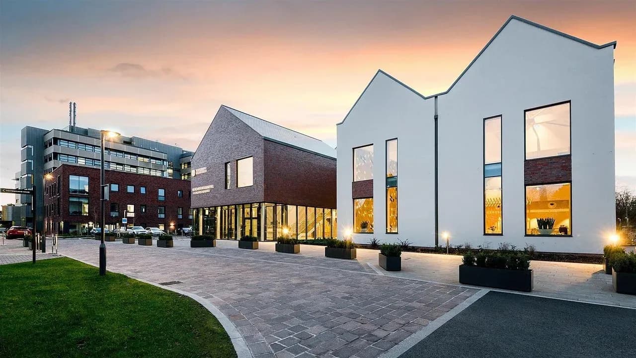 Modern Edgbaston conference centre and hotel buildings with brick and white facades at sunset.
