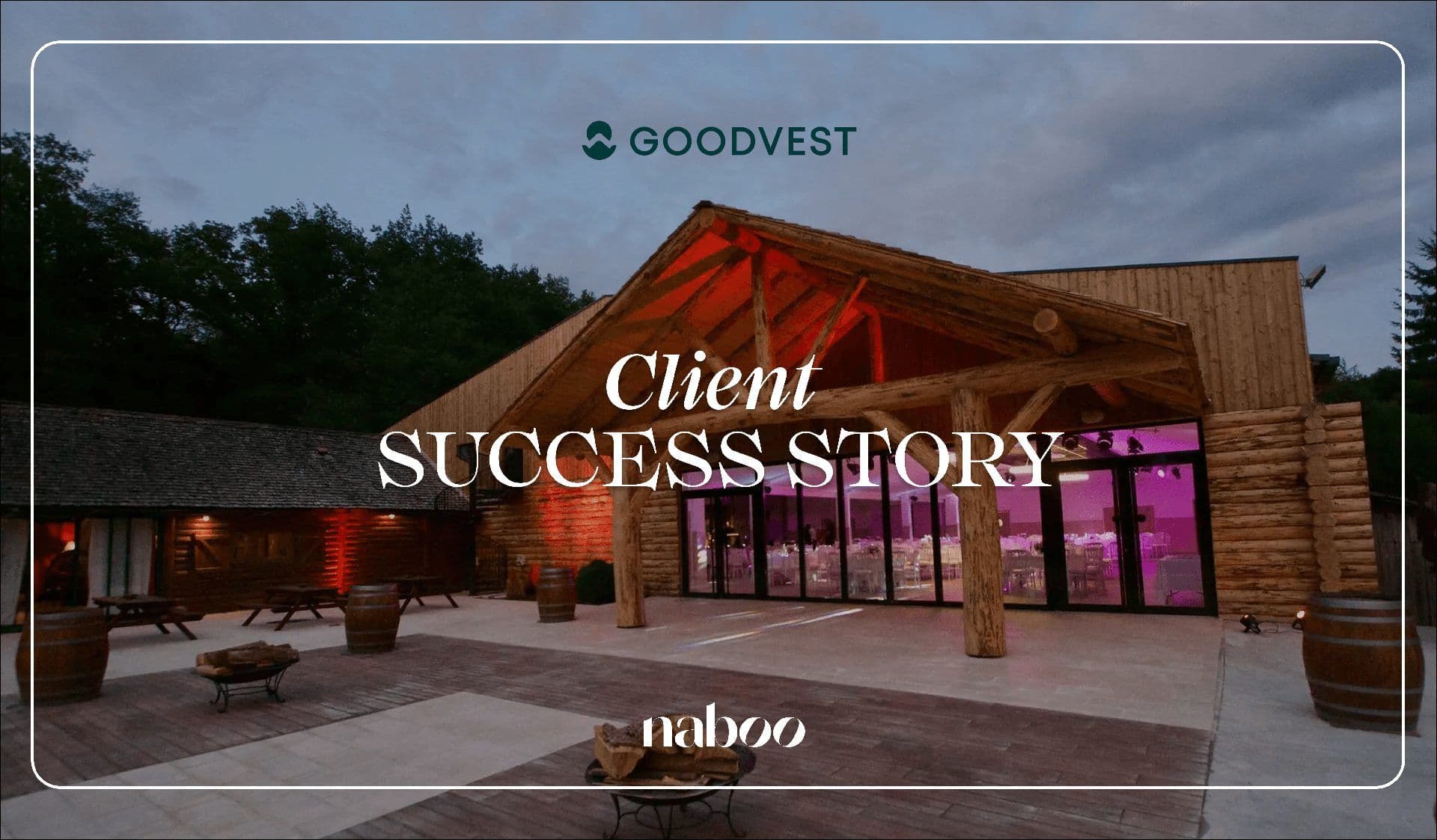 A large wooden lodge corporate event venue with an outdoor patio, illuminated for a large group event at dusk.