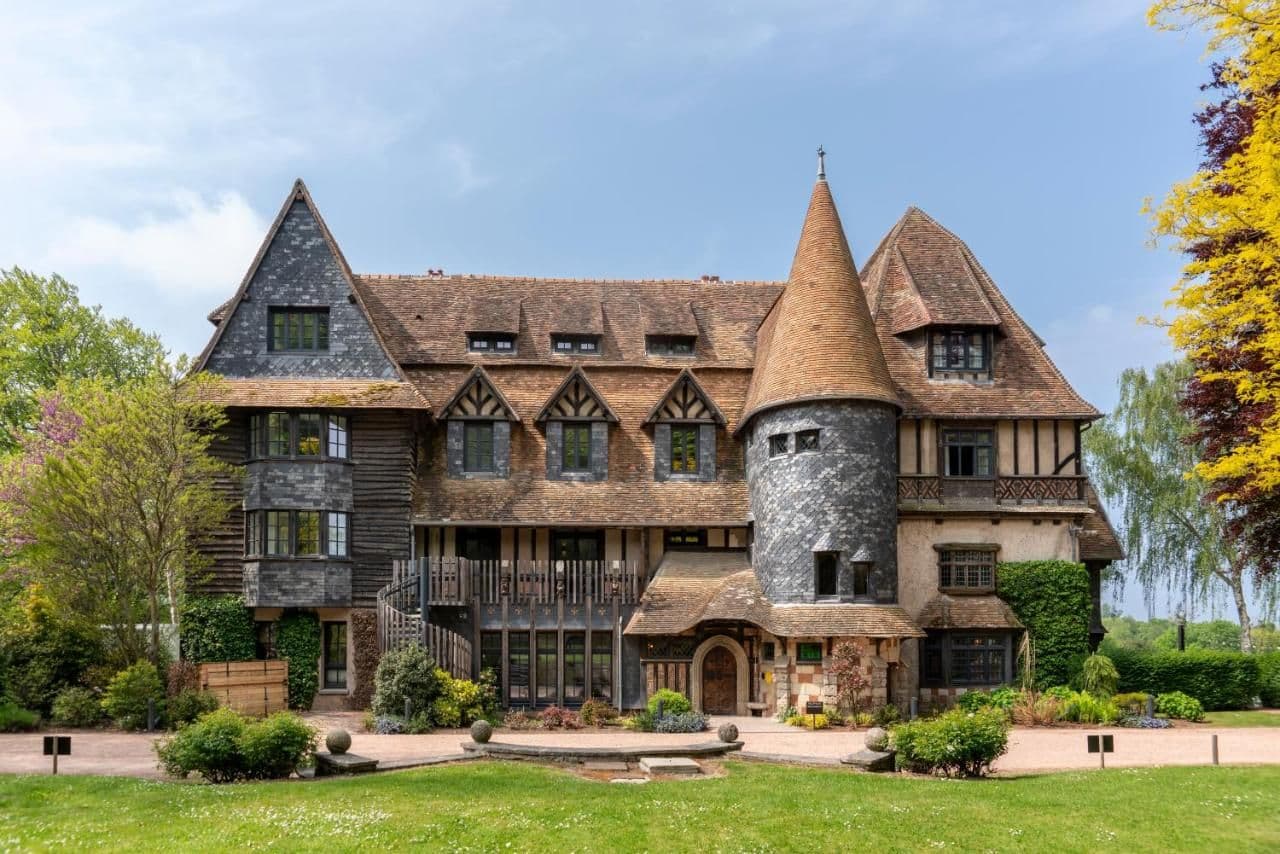 A historic corporate event venue in France, featuring a distinctive conical turret and traditional