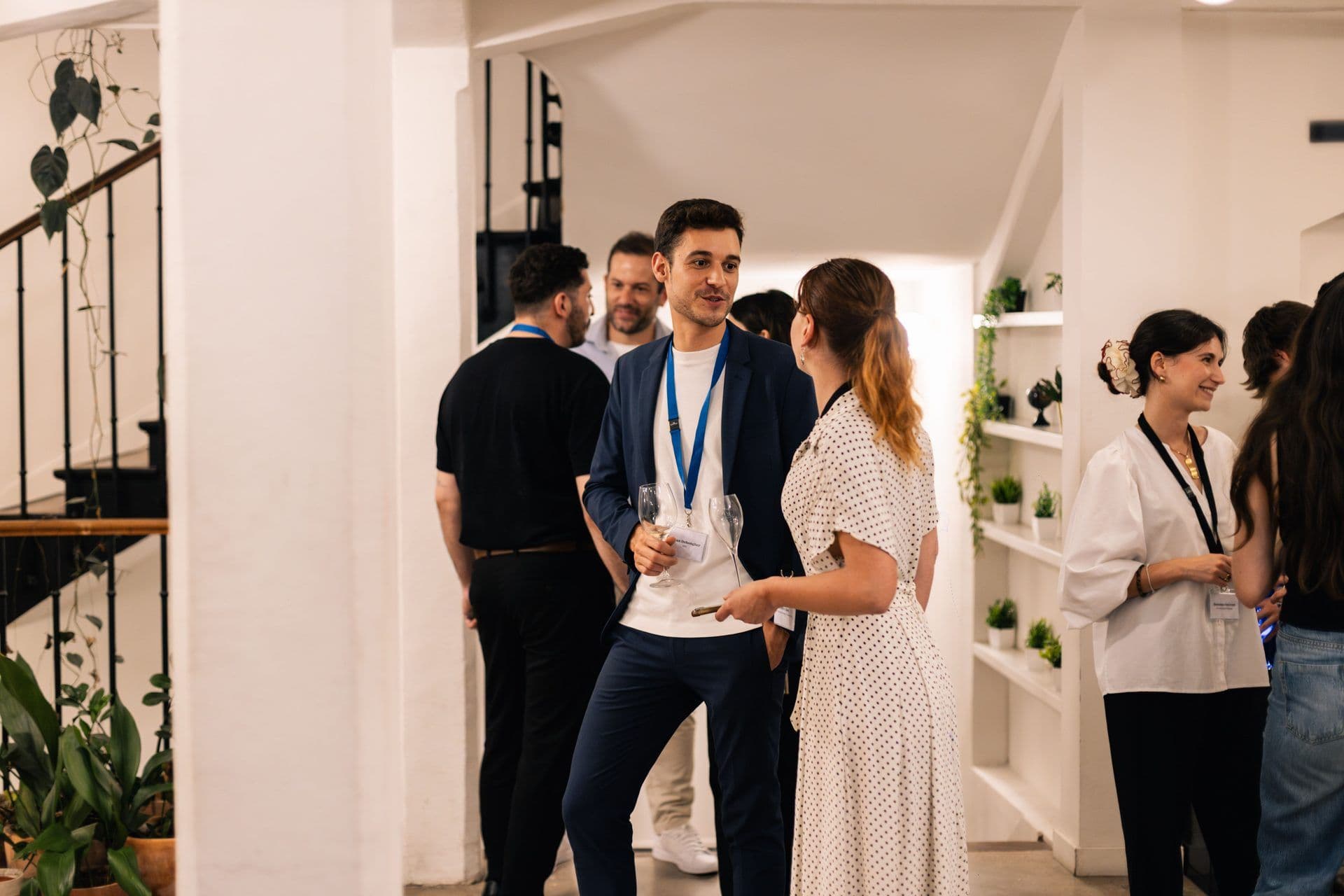 Professionals networking at a corporate event cocktail reception in a modern event space.