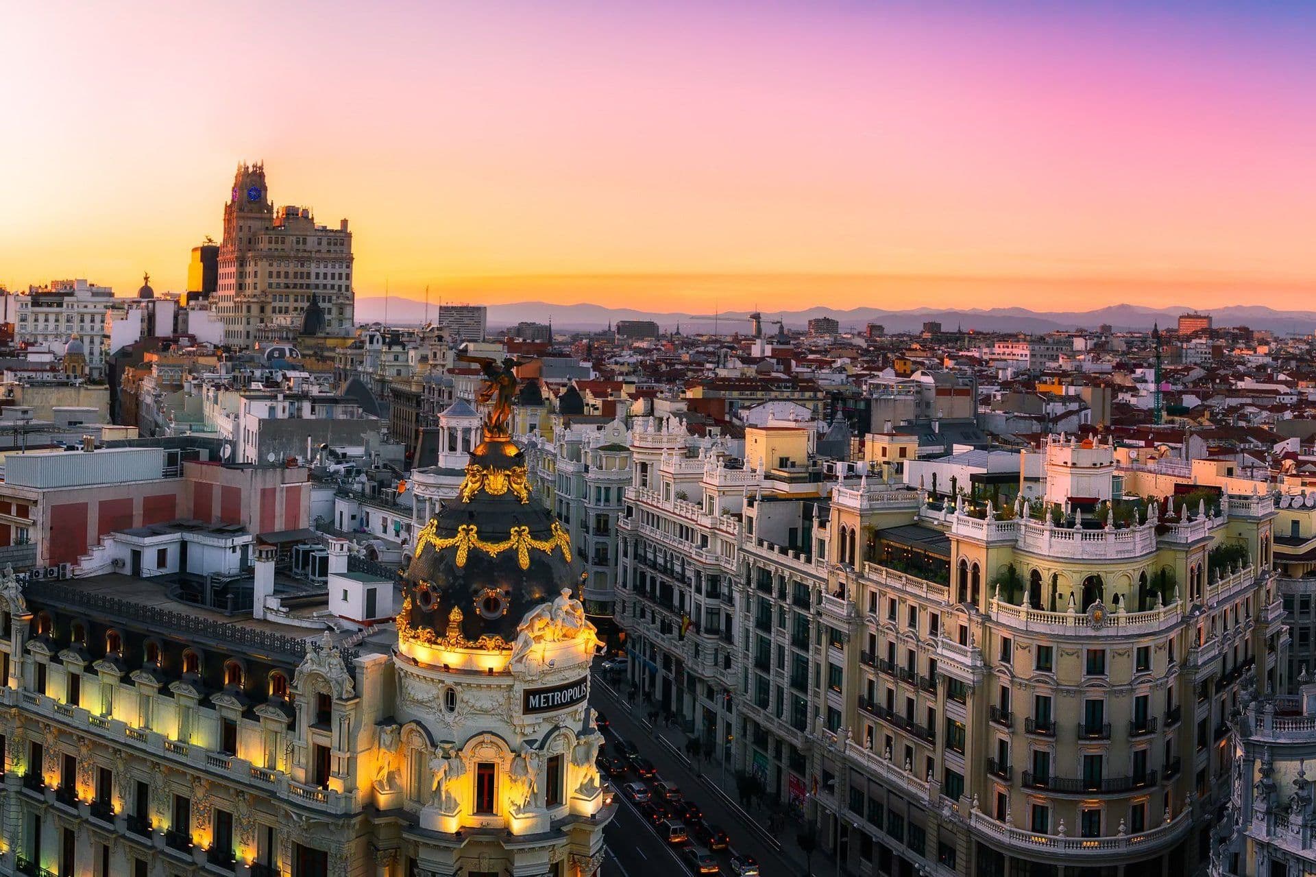 Panoramic sunset view of Madrid, Spain, showcasing historic architecture and potential rooftop event spaces.