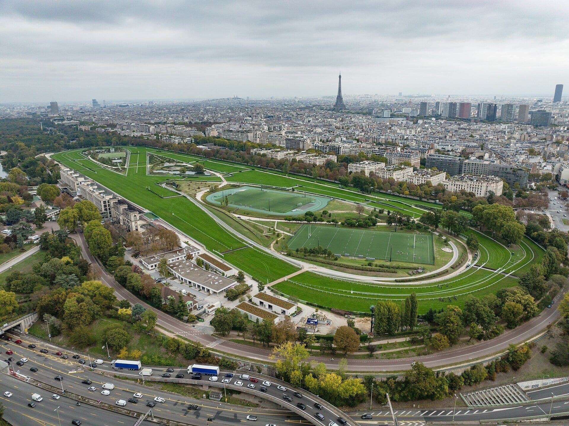 Aerial view of Hippodrome d'Auteuil, a large outdoor event space in Paris, with the Eiffel Tower.