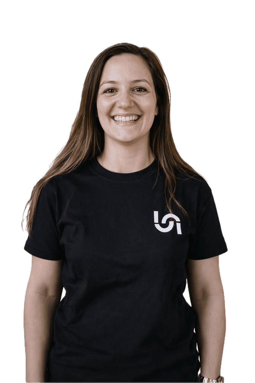 A smiling woman with long brown hair wears a black t-shirt with the white Naboo logo.