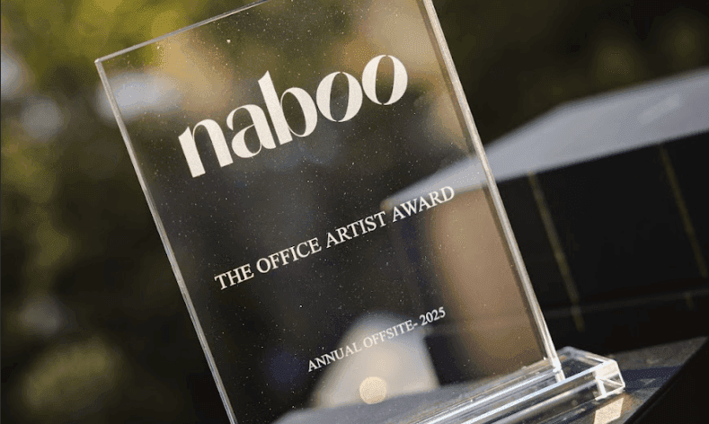 A clear acrylic award engraved with "naboo", "THE OFFICE ARTIST AWARD", and "ANNUAL OFFSITE - 2025".