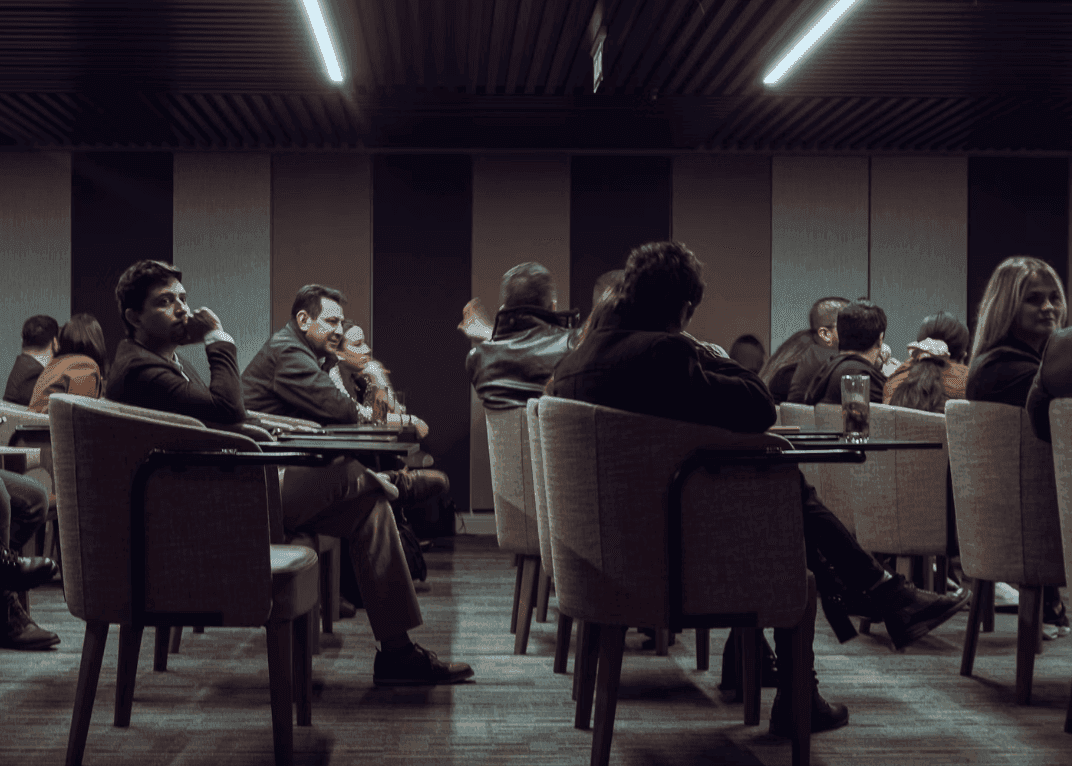 Attendees seated in a modern conference space during a corporate seminar or workshop.