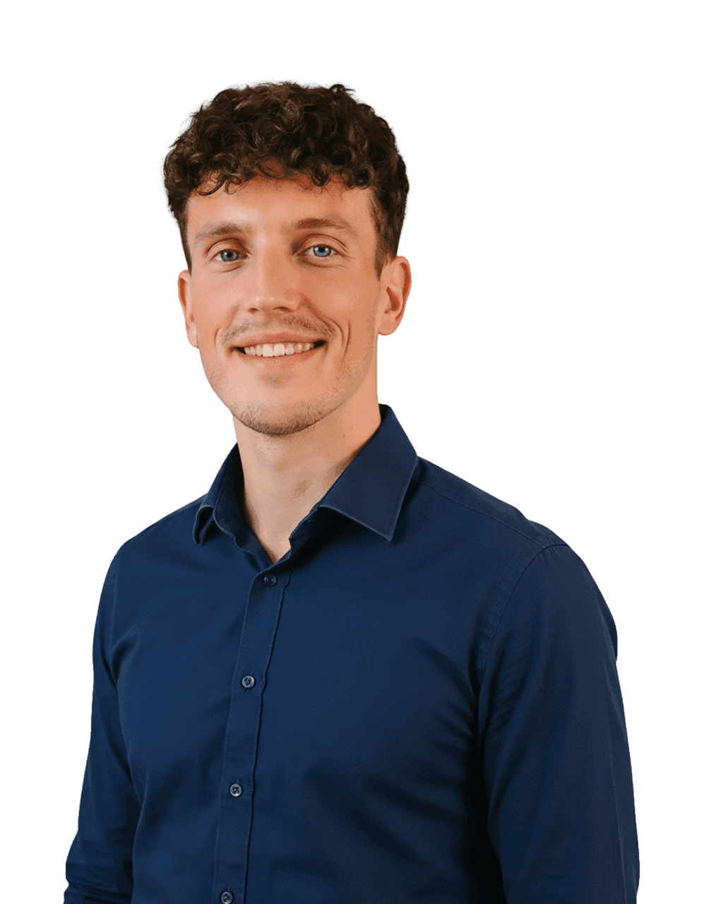 A smiling man with curly brown hair and blue eyes wears a navy blue collared shirt.