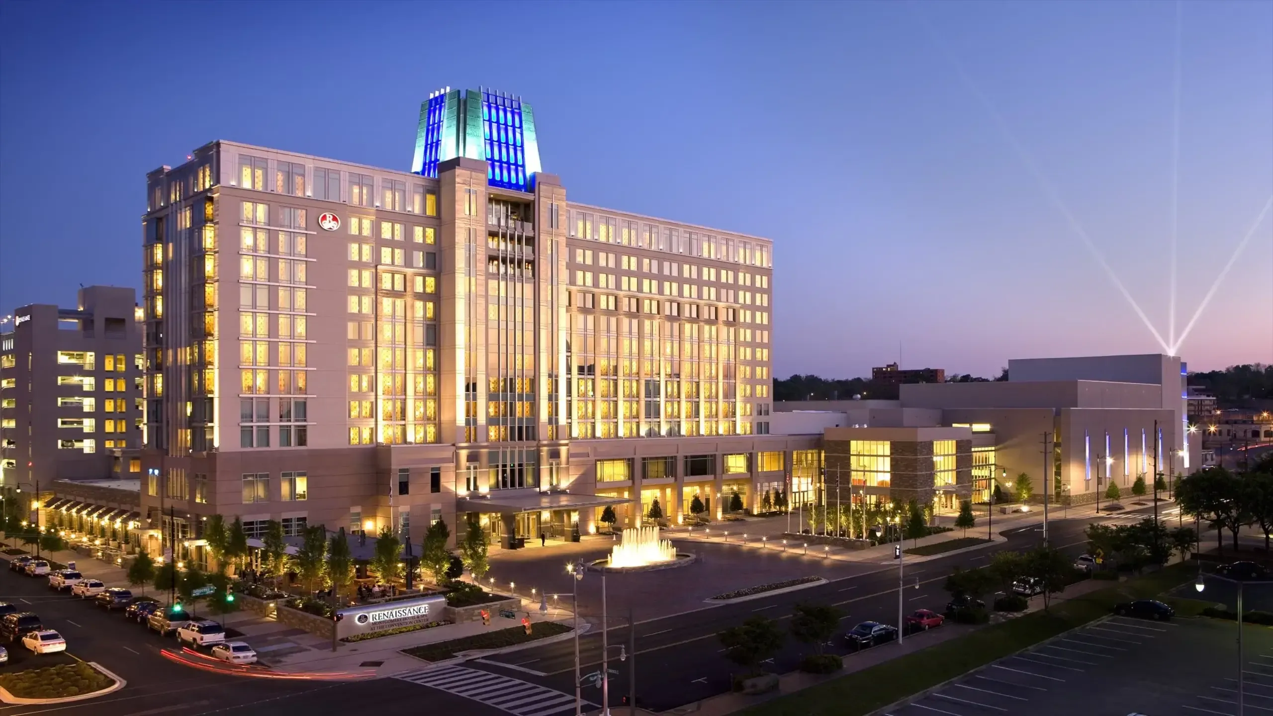 Large corporate event venue, the Renaissance Montgomery Hotel & Spa, illuminated at dusk in Alabama.