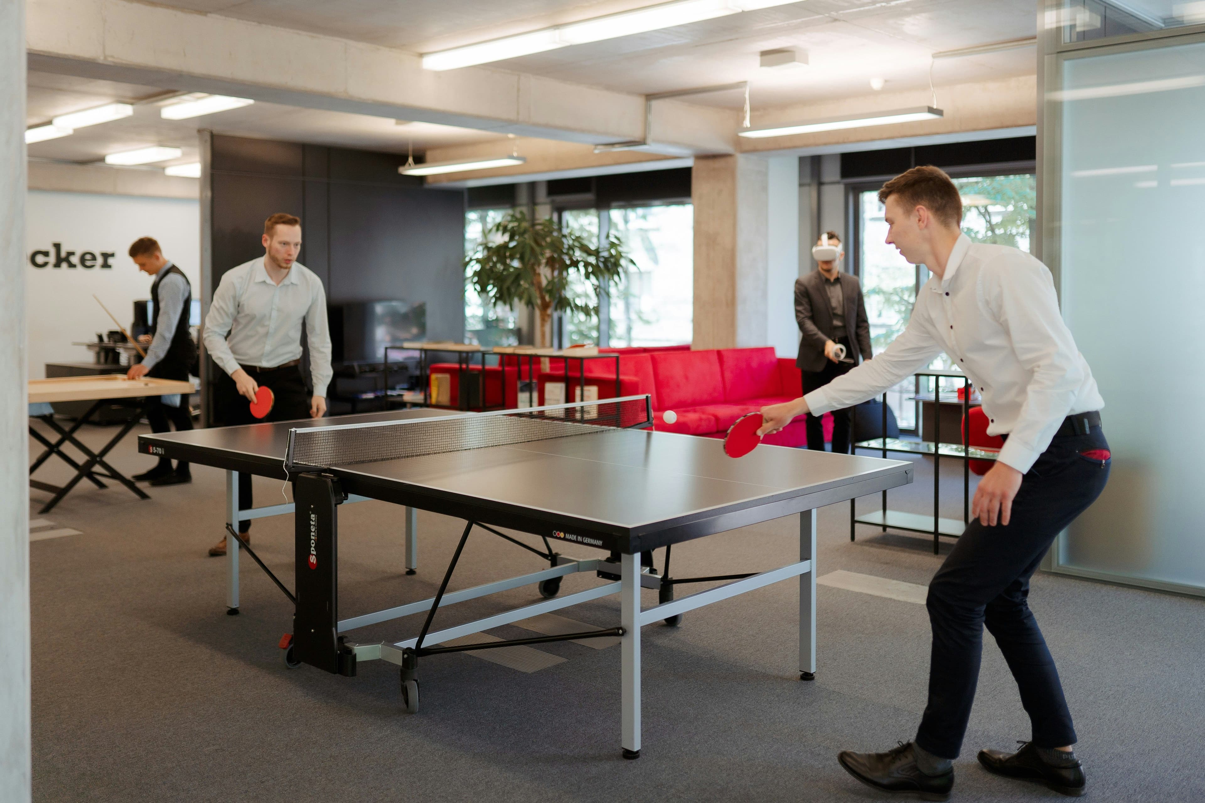 Diverse team members competing in fun office olympics games outdoors