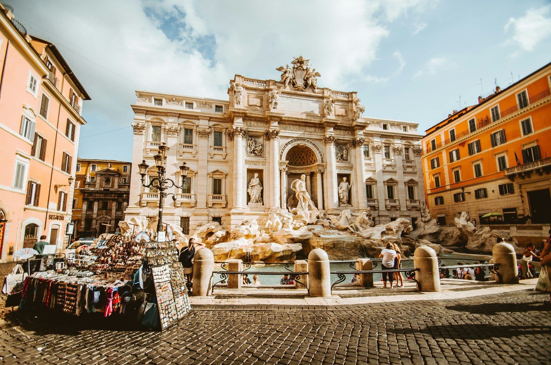 The historic Trevi Fountain in Rome, Italy, with ornate sculptures, surrounding buildings, and visitors.