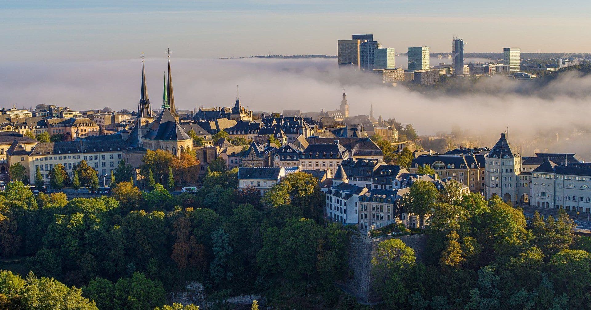 Scenic aerial view of Luxembourg City, showcasing historic and modern corporate event venues amidst morning
