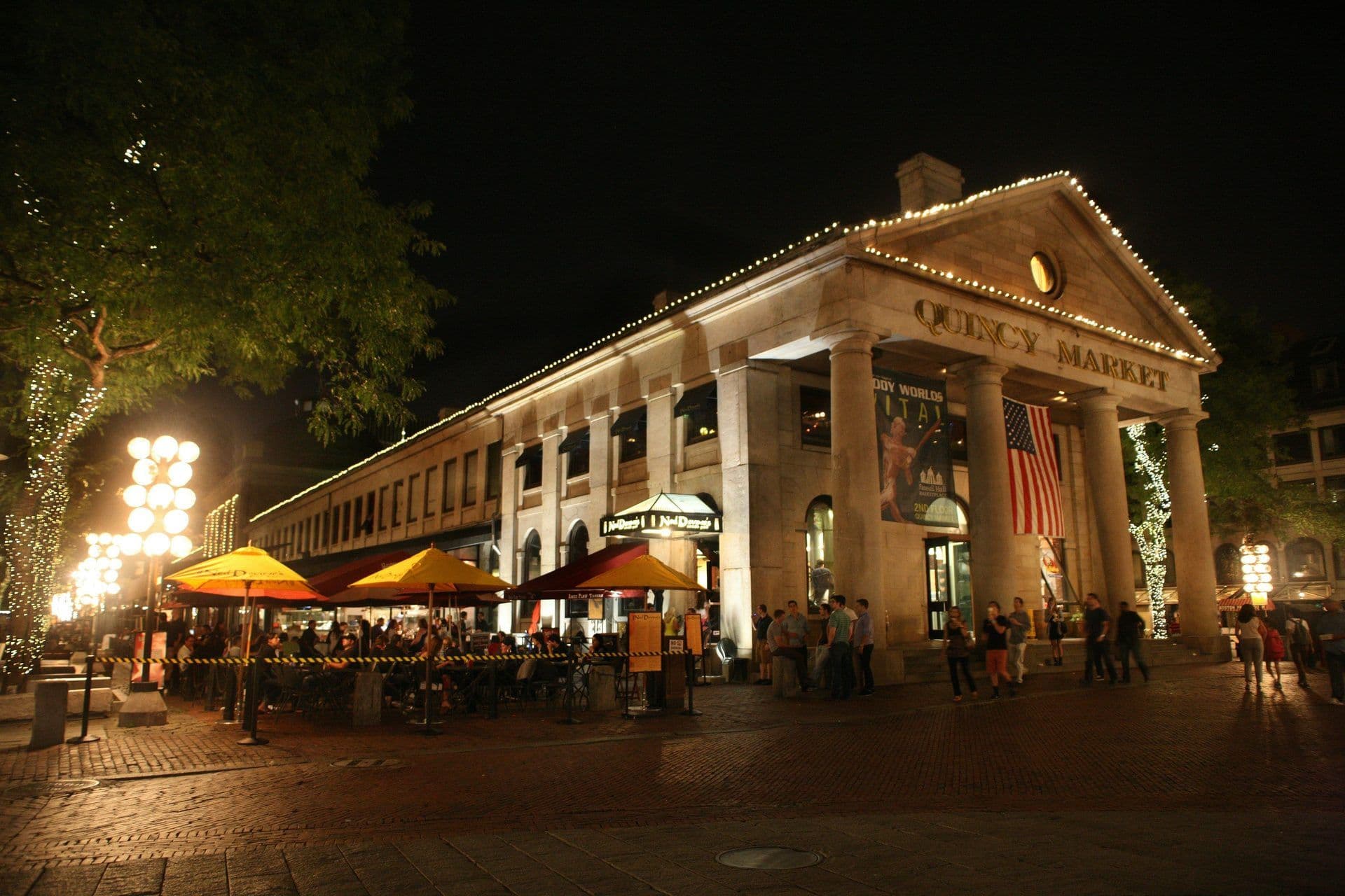 Historic Quincy Market in Boston at night, illuminated for an outdoor corporate dinner or networking event.