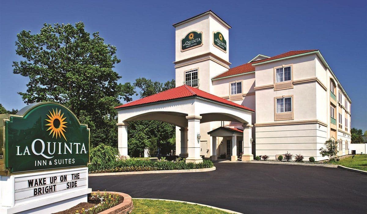 Exterior view of a La Quinta Inn & Suites hotel, a suitable overnight seminar venue with a covered entrance.
