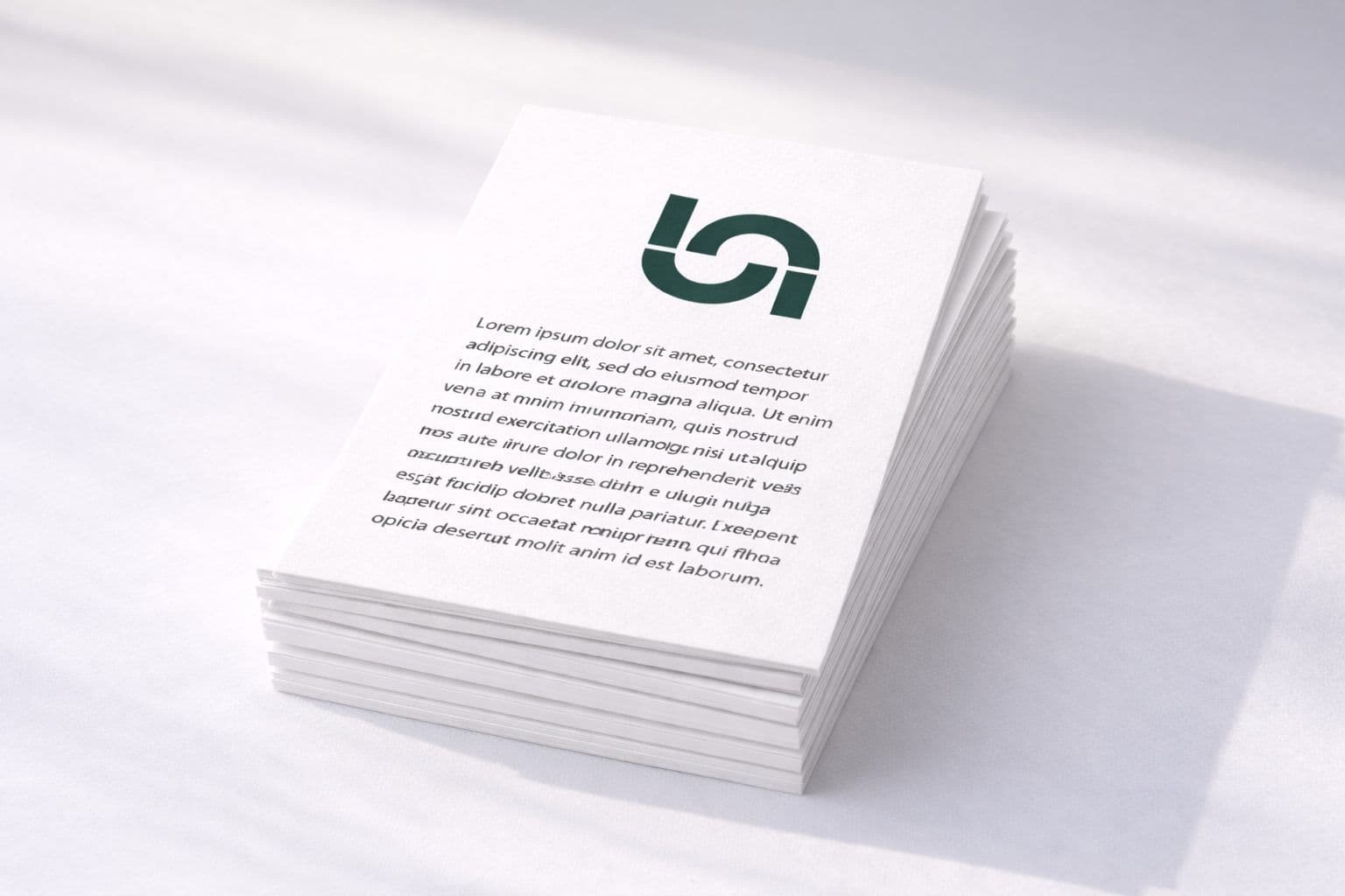 Clean stack of white corporate event branding materials with a dark green logo.