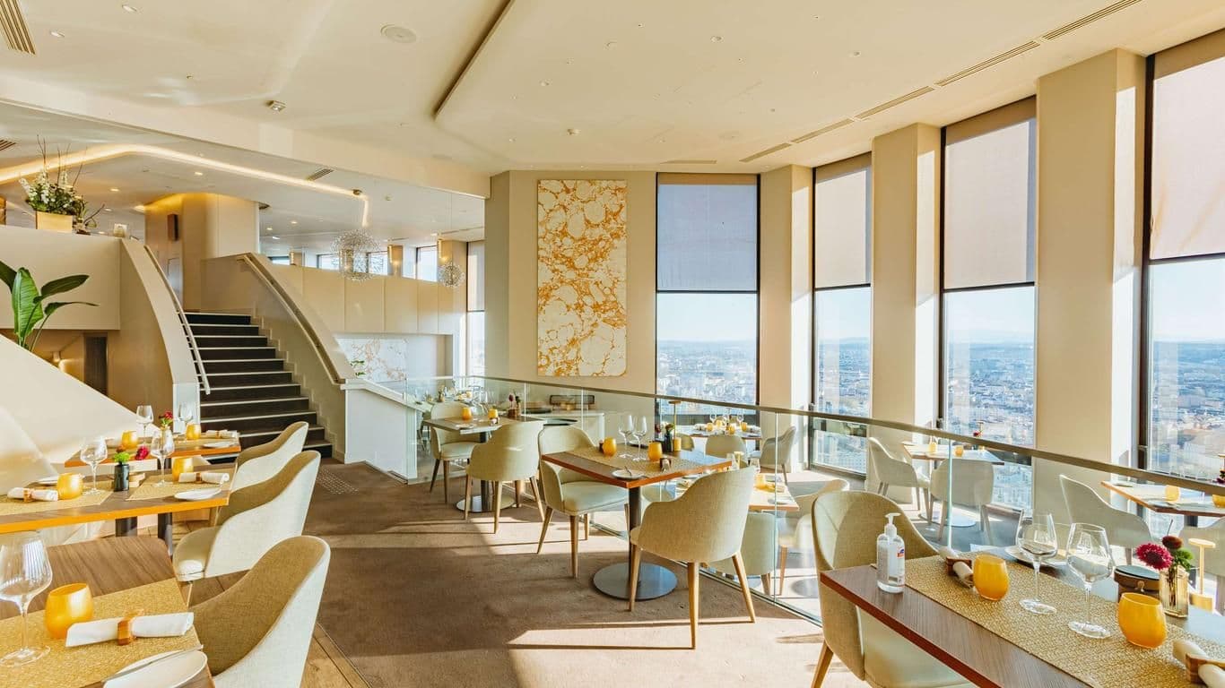 Spacious corporate event venue featuring multiple dining levels and panoramic city views.