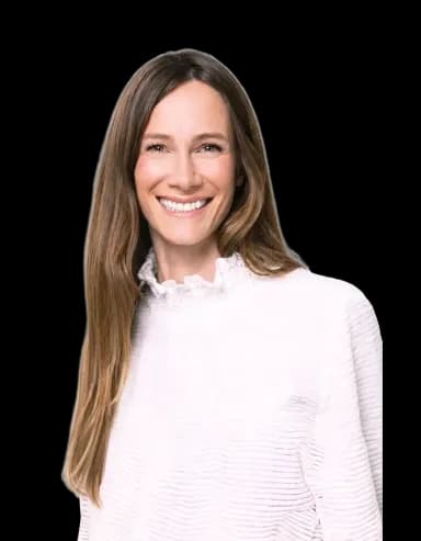 Professional portrait of Laure Cavalié, a smiling woman with long brown hair and a white ruffled top.
