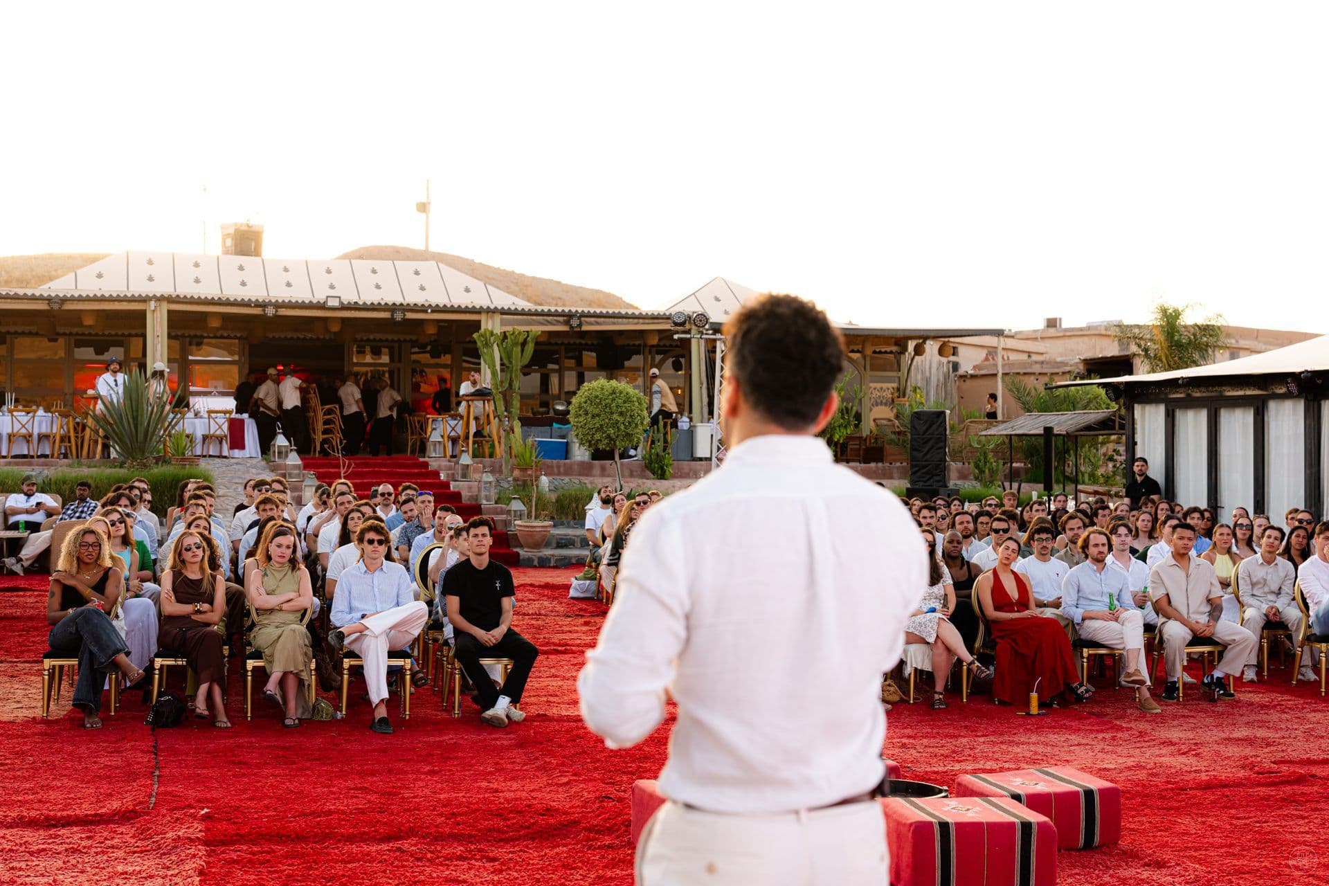 Naboo founders giving a keynote to the whole team seated on a red carpet at the 2026 company offsite