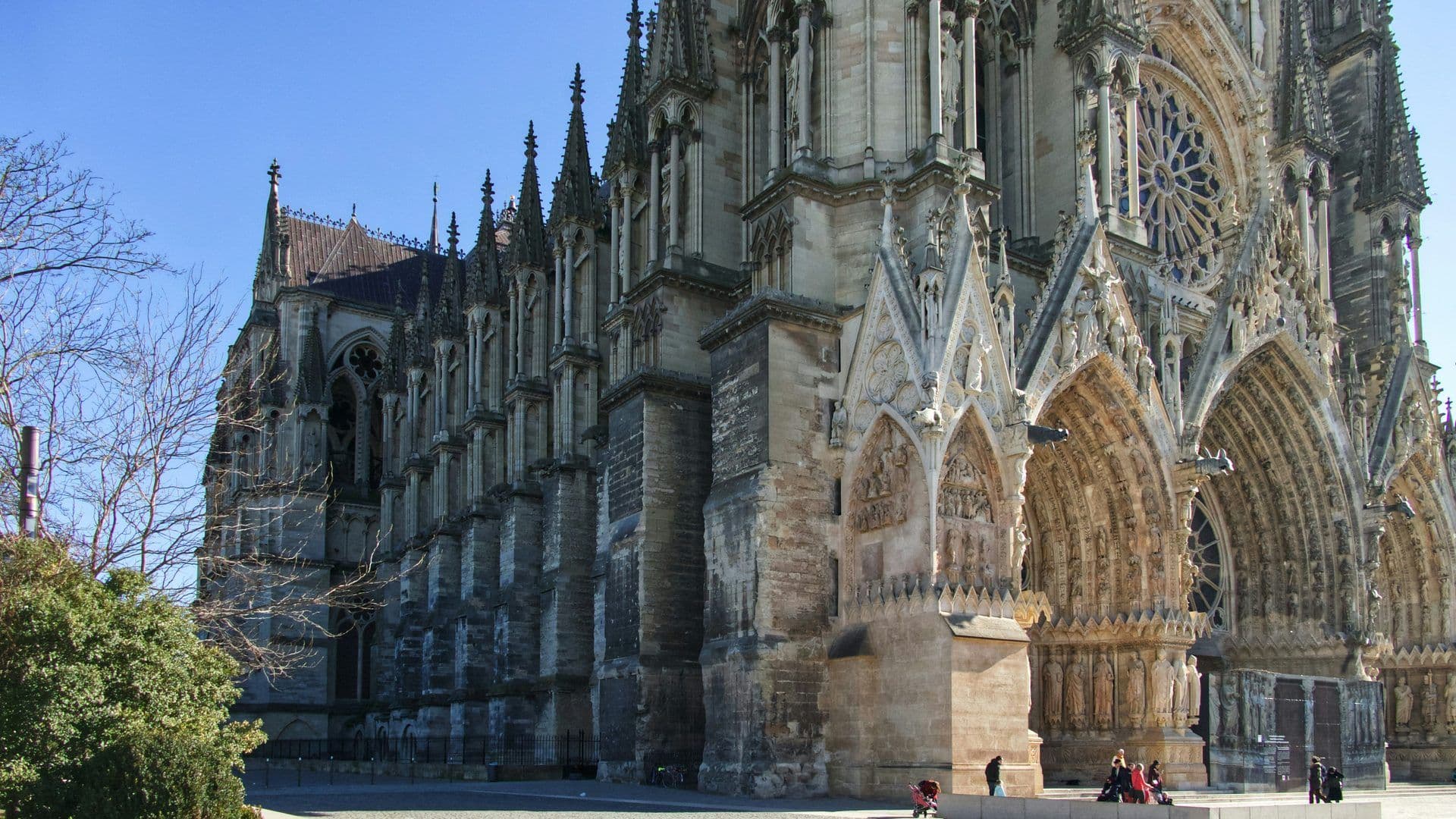 Historic Reims Cathedral in France, an impressive Gothic venue with detailed sculptures and a grand rose