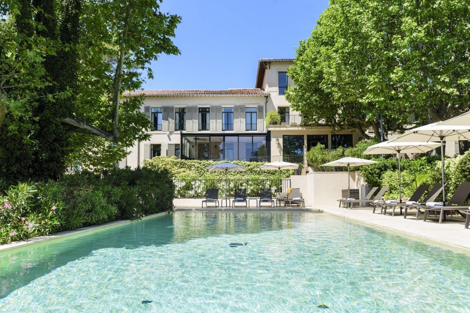 A luxurious corporate retreat venue with a swimming pool and sun loungers in Provence, France.