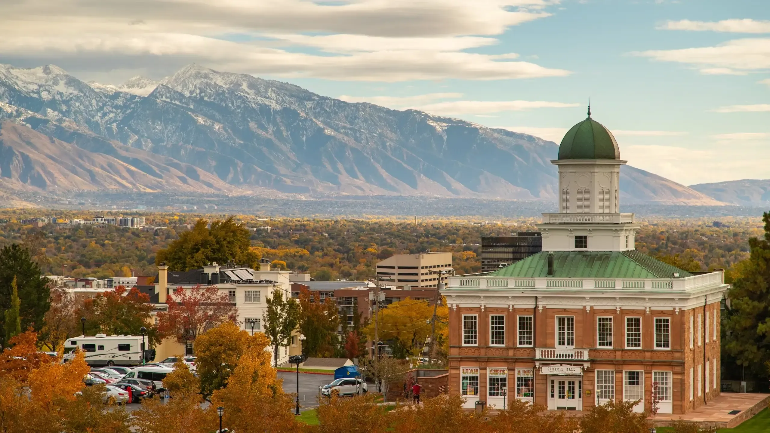 A historic corporate event venue, Council Hall in Salt Lake City, surrounded by autumn foliage and mountains.