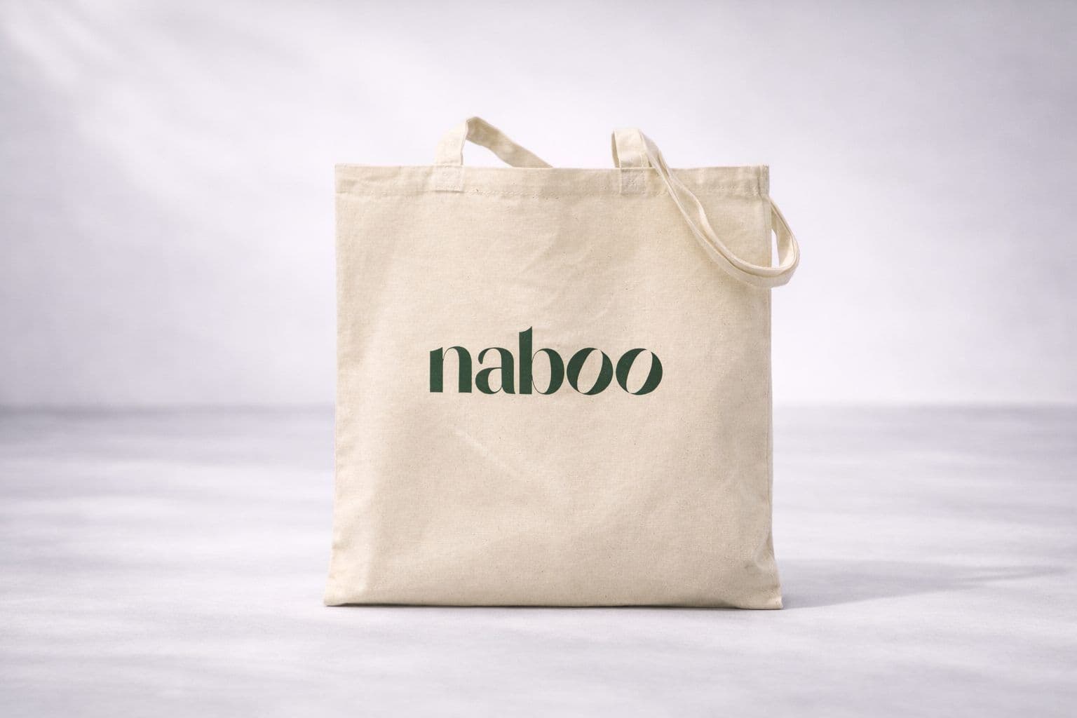 Light beige canvas tote bag with the Naboo logo in dark green, perfect for corporate events.