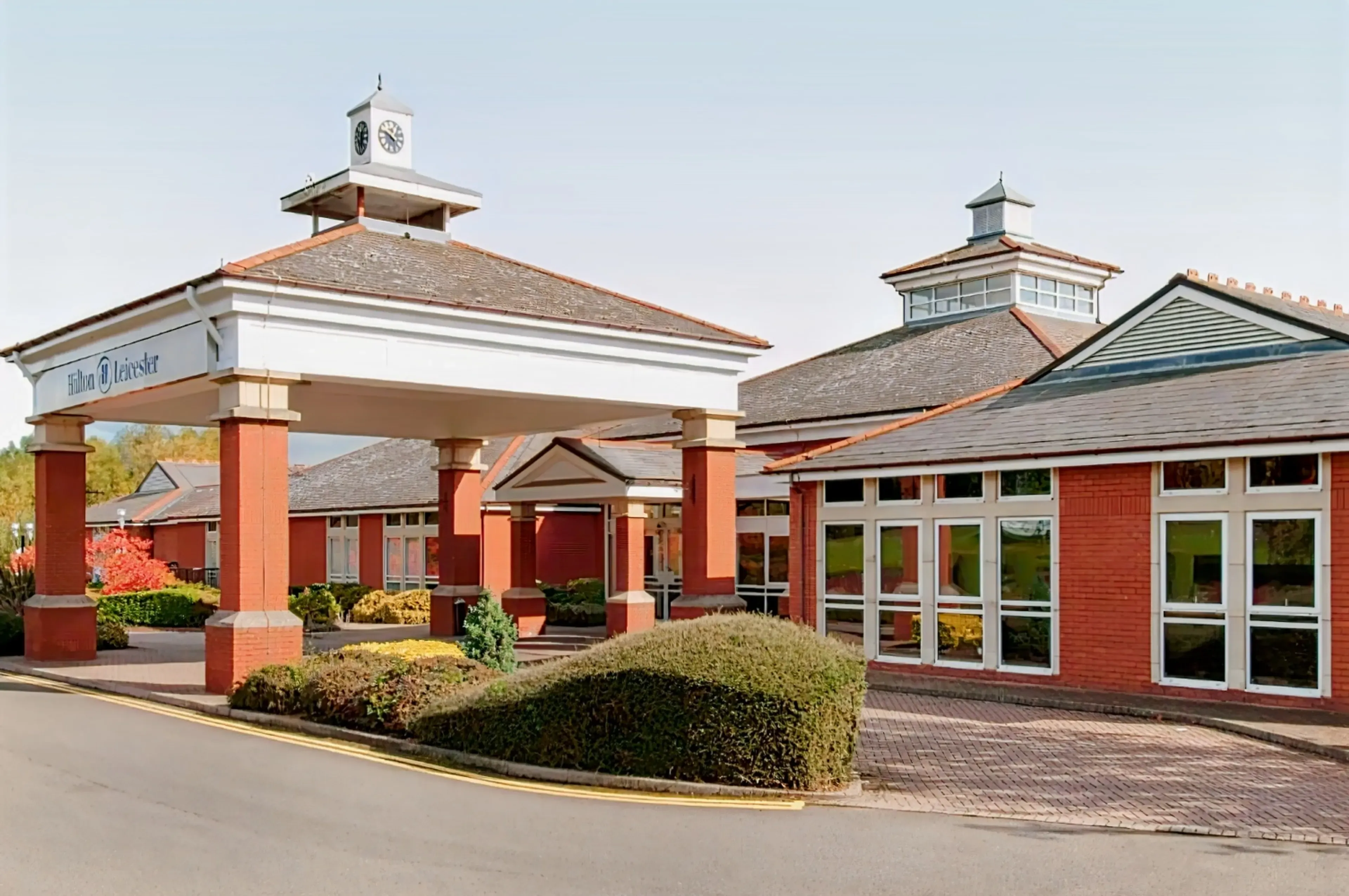 The Hilton Leicester hotel entrance, a red brick corporate event venue with a clock tower.