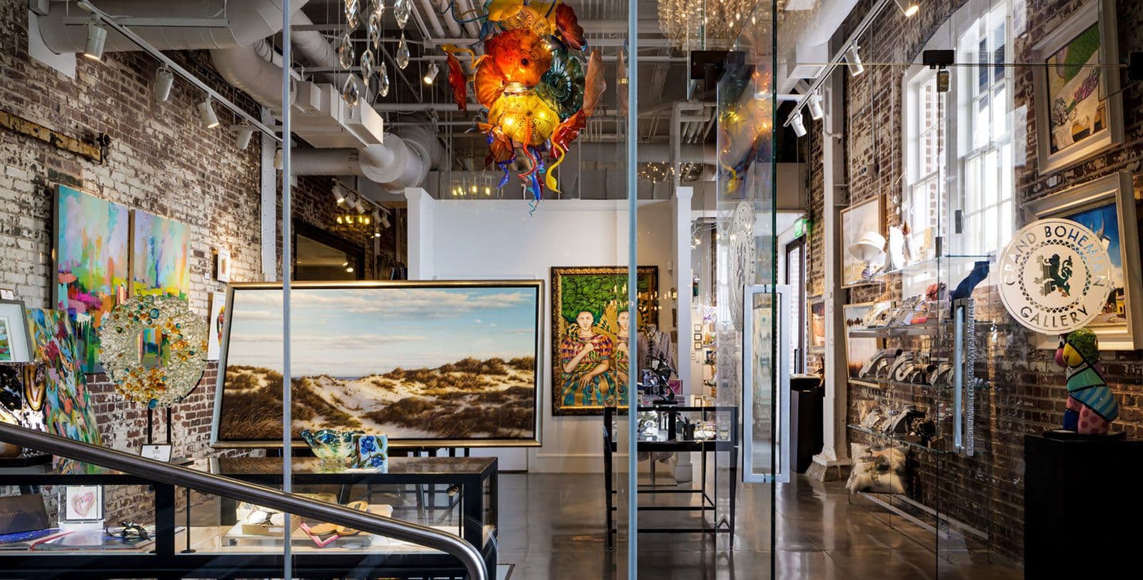 Unique corporate event venue in Savannah, an art gallery with exposed brick walls and colorful glass art.