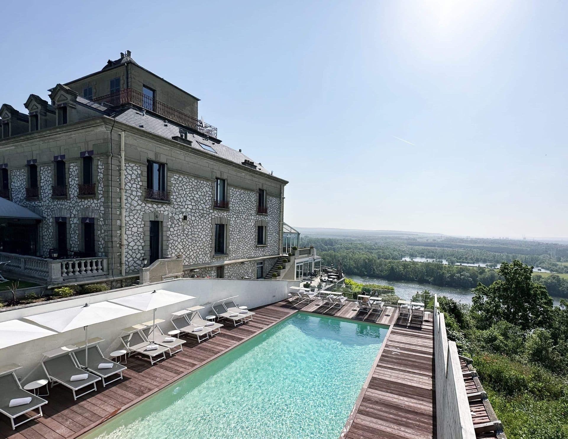 Historic stone corporate event venue with an outdoor swimming pool and river views