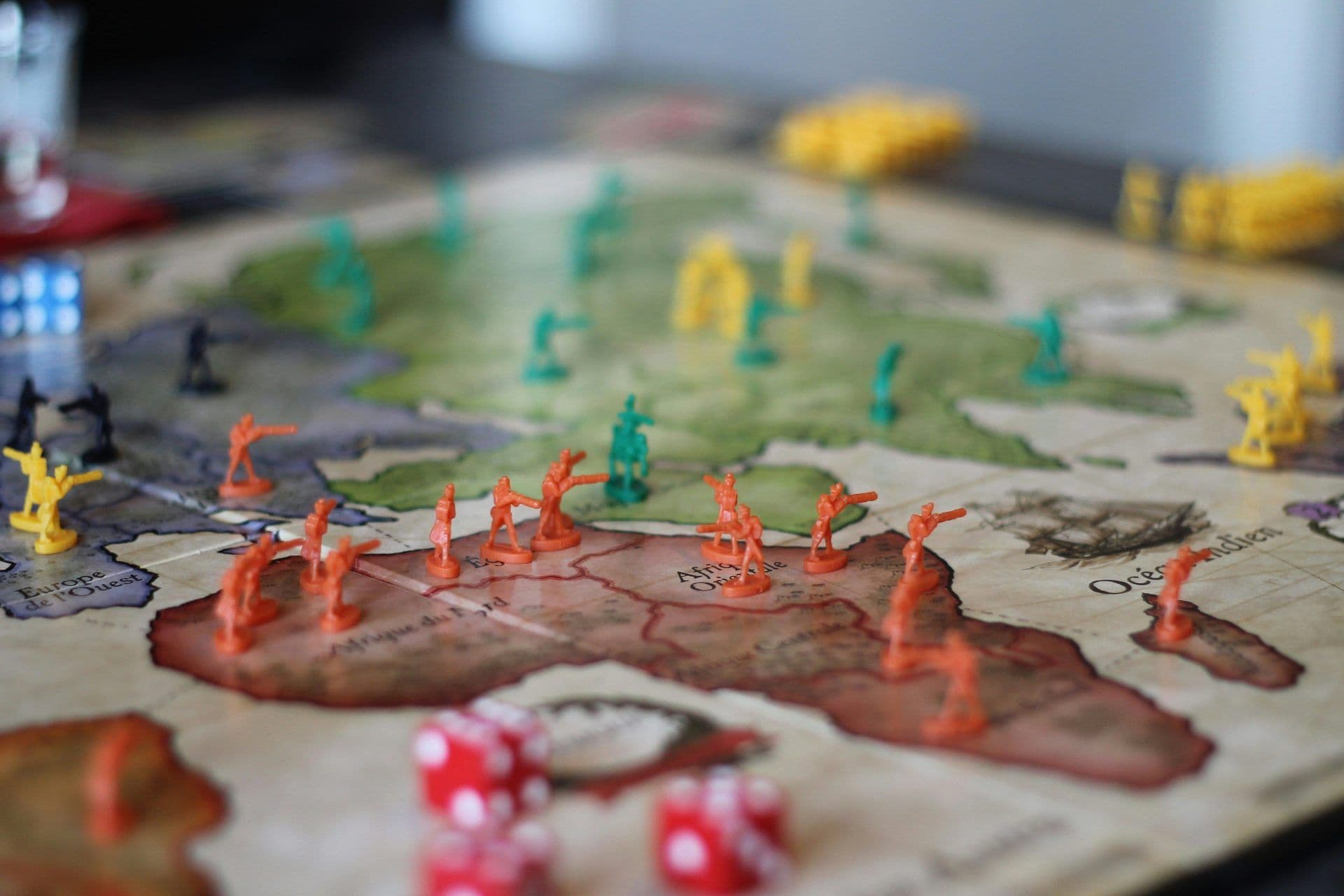 A strategy board game with miniature soldiers and dice, ideal for corporate team building activities.