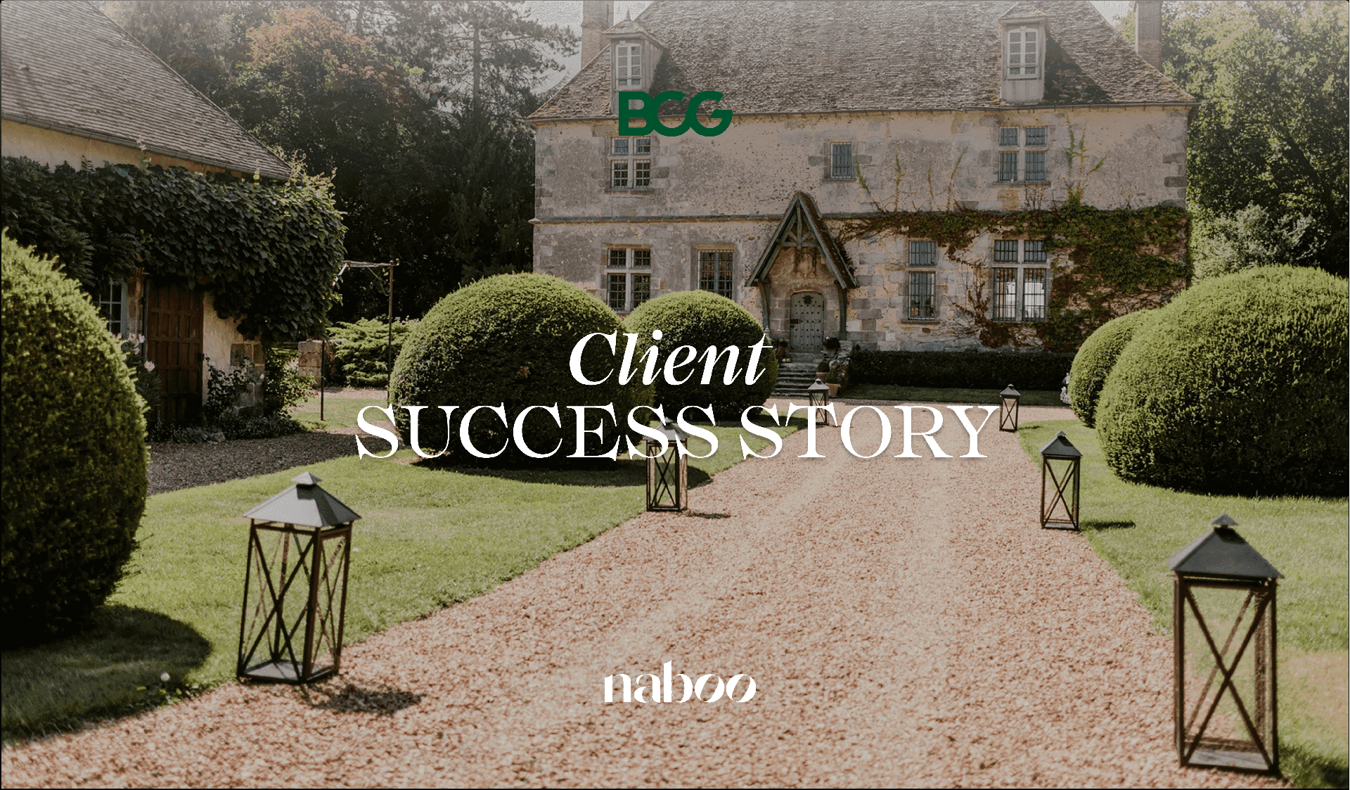 A historic stone corporate event venue with a gravel path, manicured lawns, and lanterns.