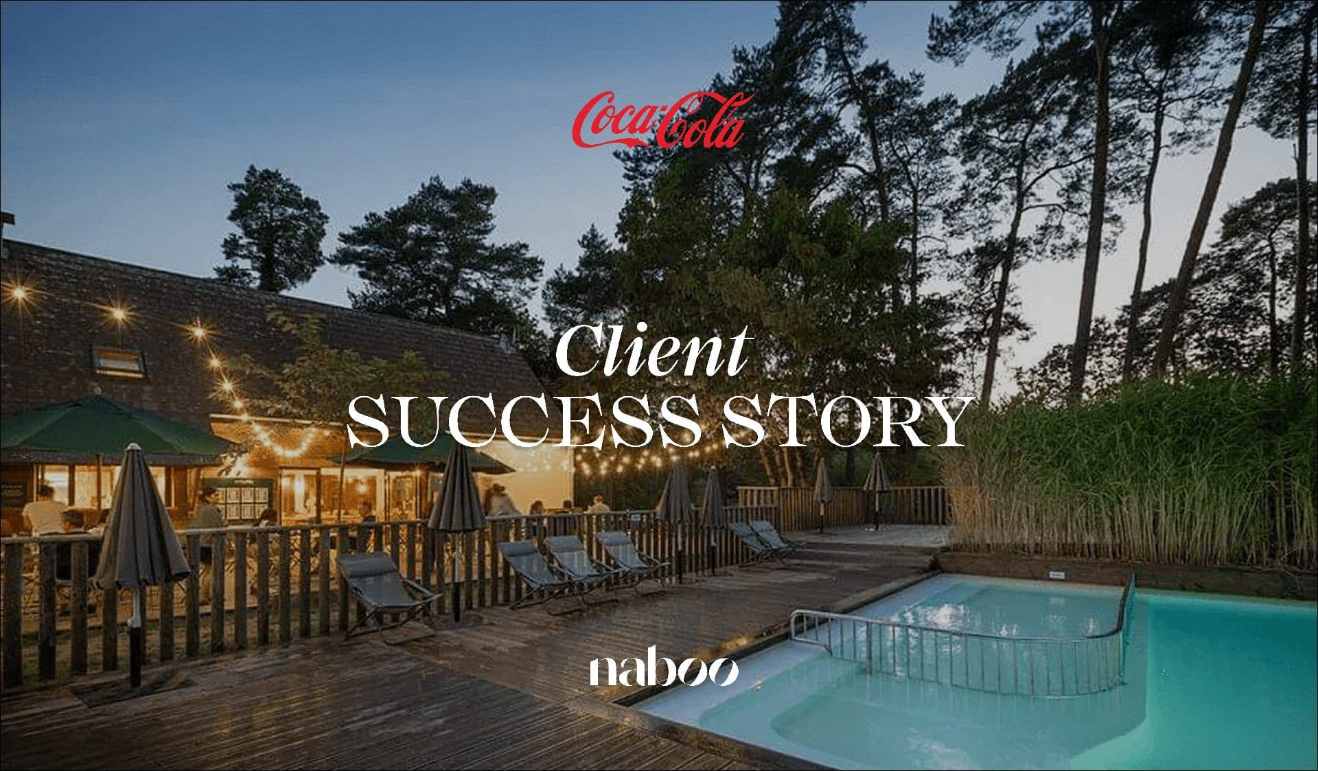 An inviting outdoor corporate retreat venue at dusk, featuring a lit building, wooden deck, and pool.