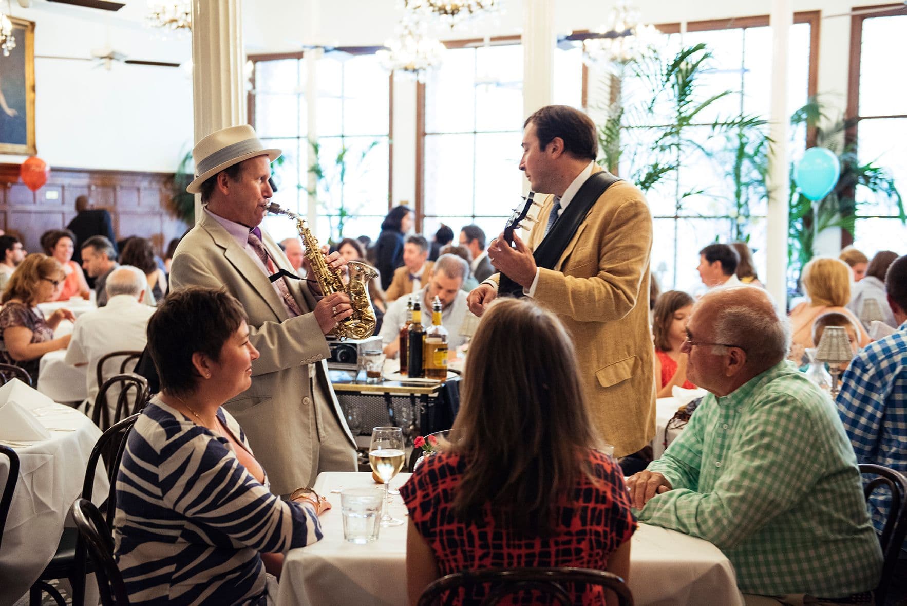 Live jazz musicians entertain guests at a corporate dinner in a spacious private dining room.
