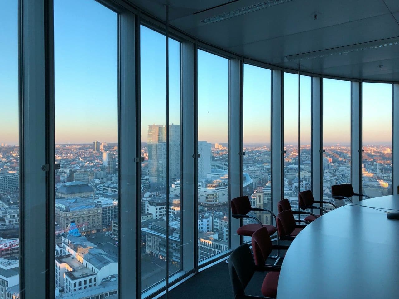 Executive boardroom with panoramic city views, ideal for corporate seminars or offsite meetings.
