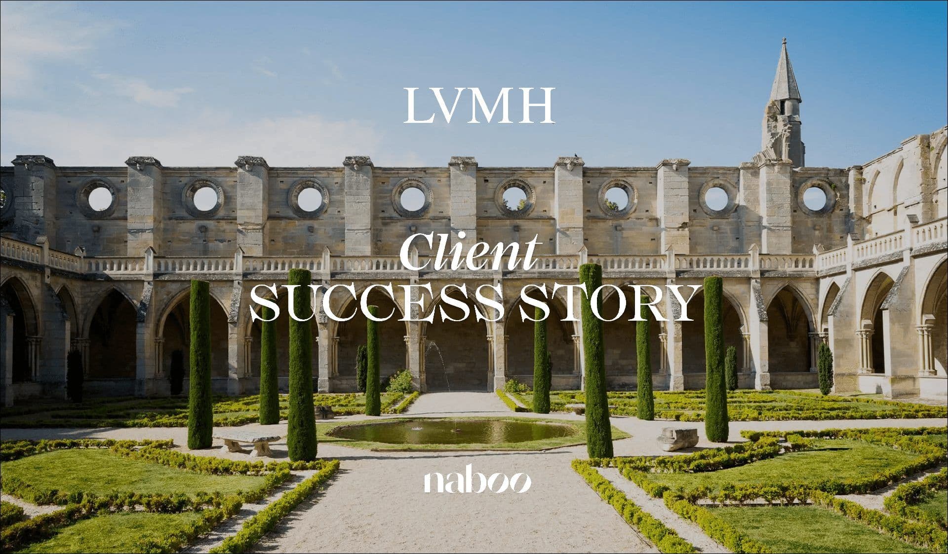 A grand historic stone building with a manicured courtyard garden and fountain