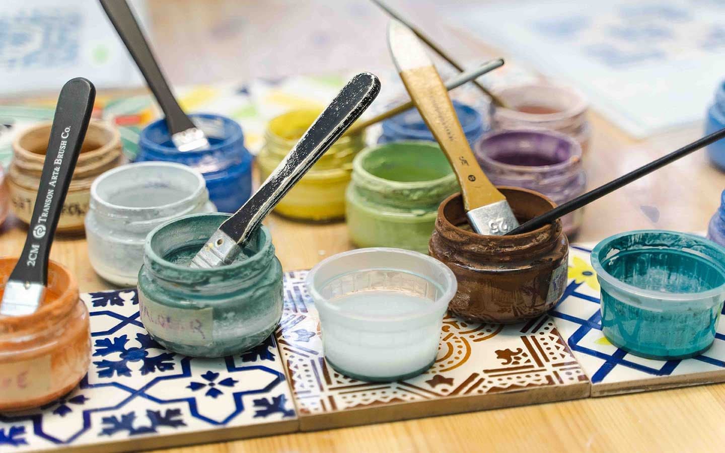 Paint pots and brushes on traditional Portuguese azulejos