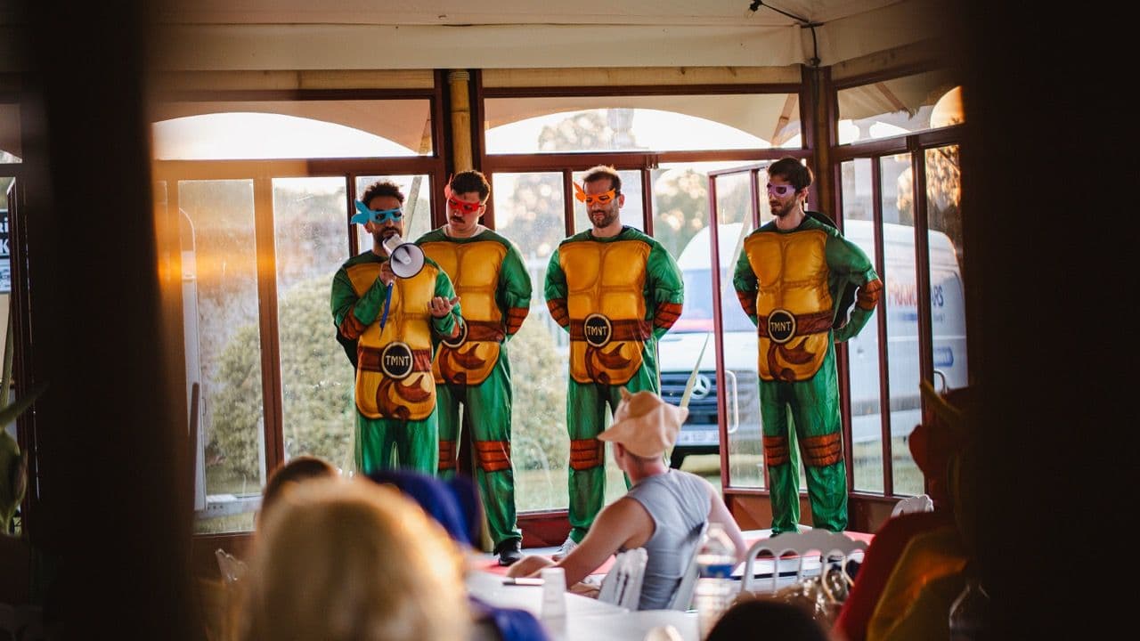 Four men in Ninja Turtle costumes lead a fun corporate team building activity for an enterprise event.