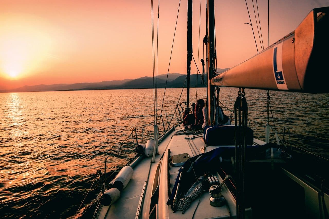 Sailboat on calm water at sunset, perfect for an outdoor team activity or corporate incentive trip.