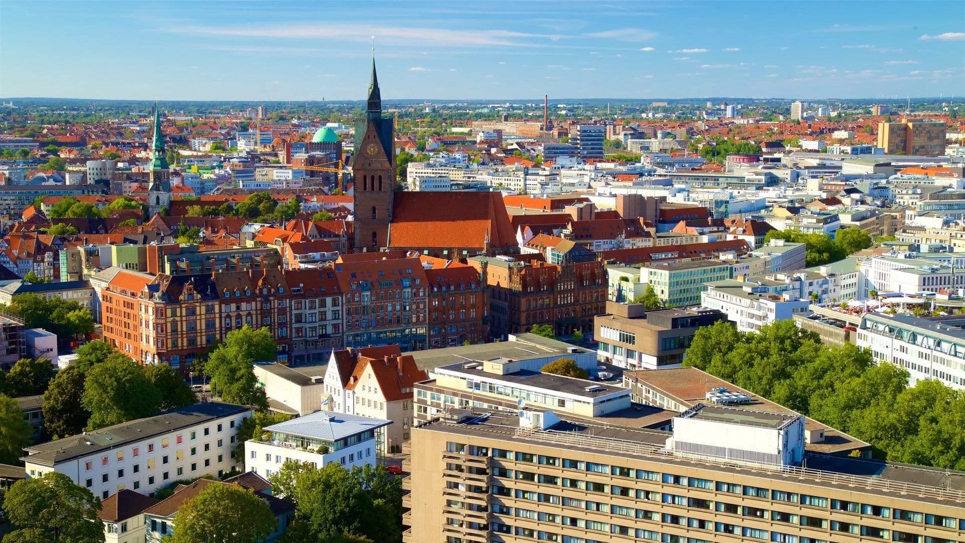 Hannover city skyline with historic buildings, a prominent church, and modern corporate event venues.