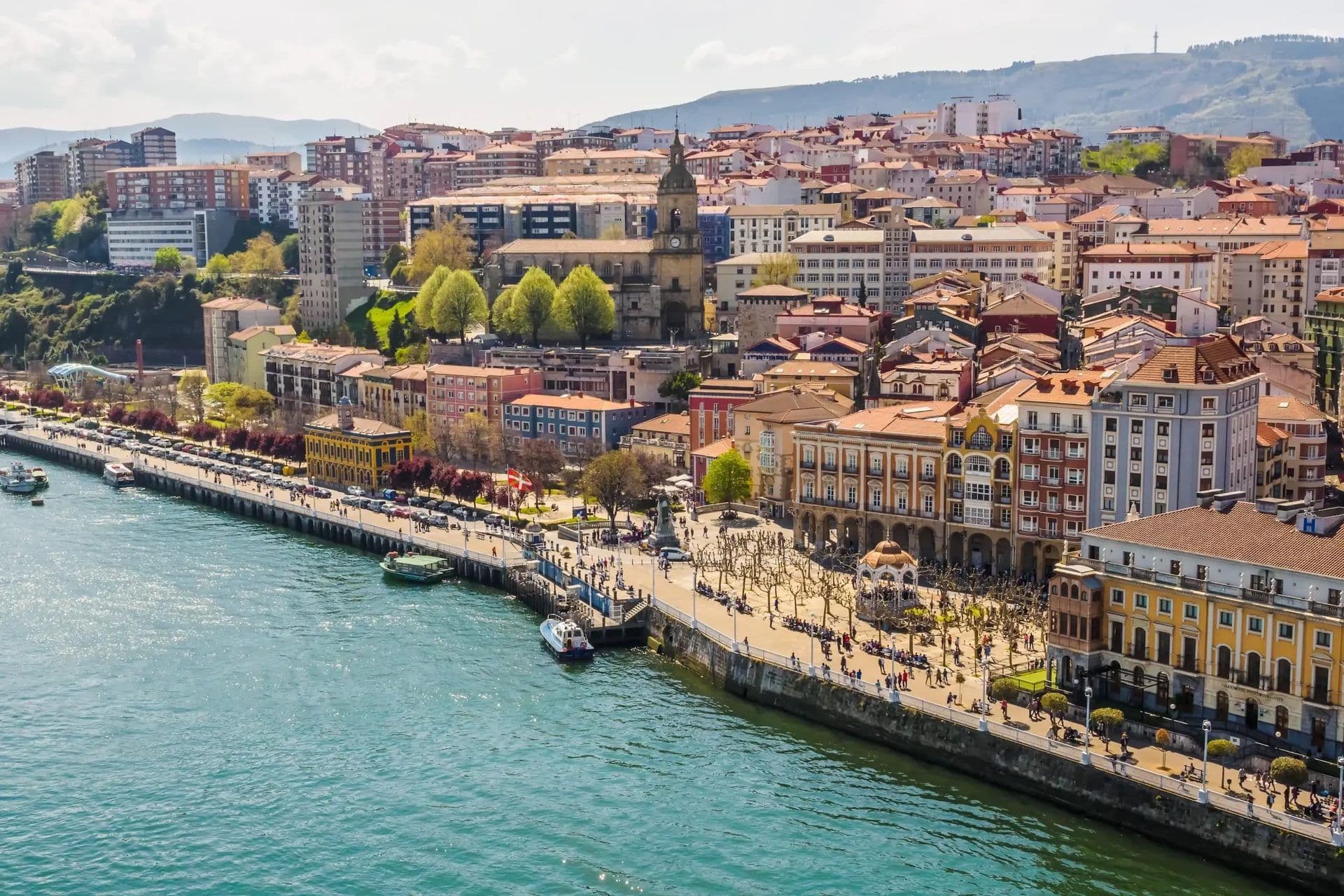 Aerial view of Bilbao, Spain, showcasing a vibrant waterfront venue, historic buildings