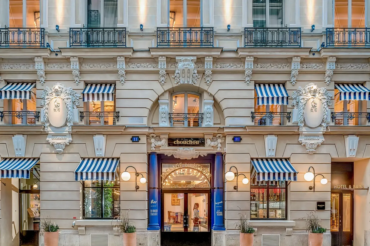 Chouchou Hotel in Paris, a historic corporate event venue with blue and white striped awnings and ornate