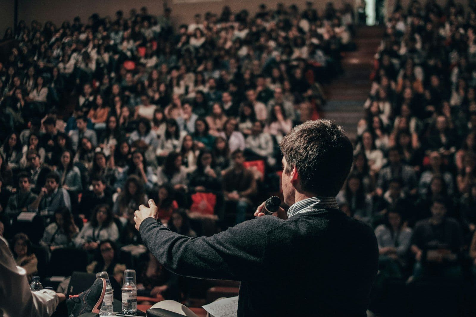 Host speaking to an audience with a microphone