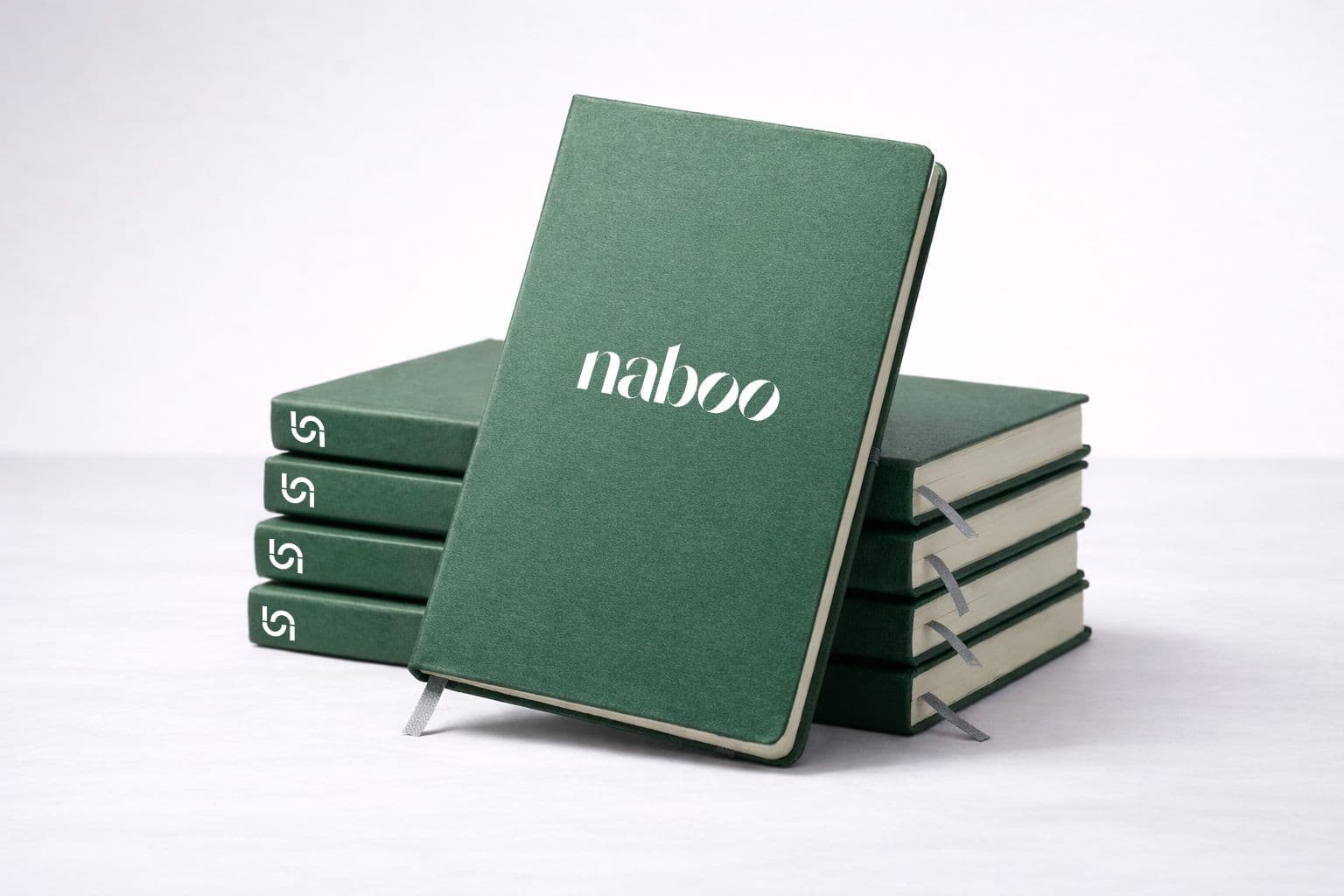 Branded dark green Naboo notebooks with grey ribbon bookmarks, ideal for corporate events and seminars.