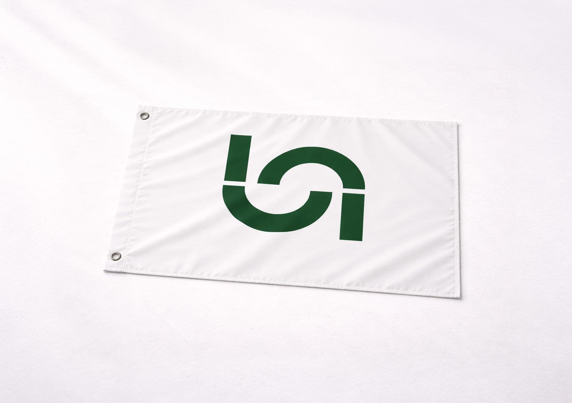 A white flag with the dark green Naboo logo for corporate event planning hangs on a textured wall.