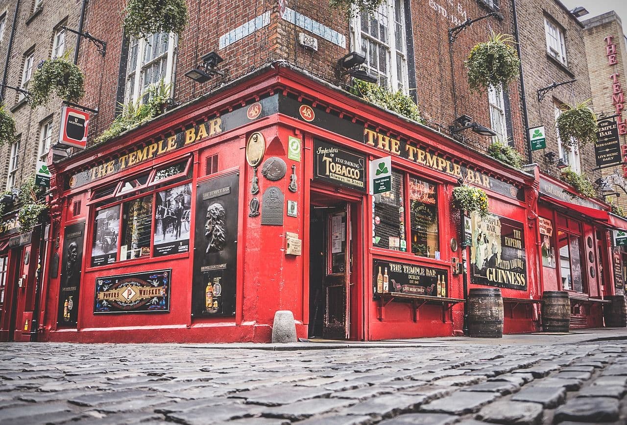 The iconic red Temple Bar pub in Dublin, Ireland, on a cobblestone street