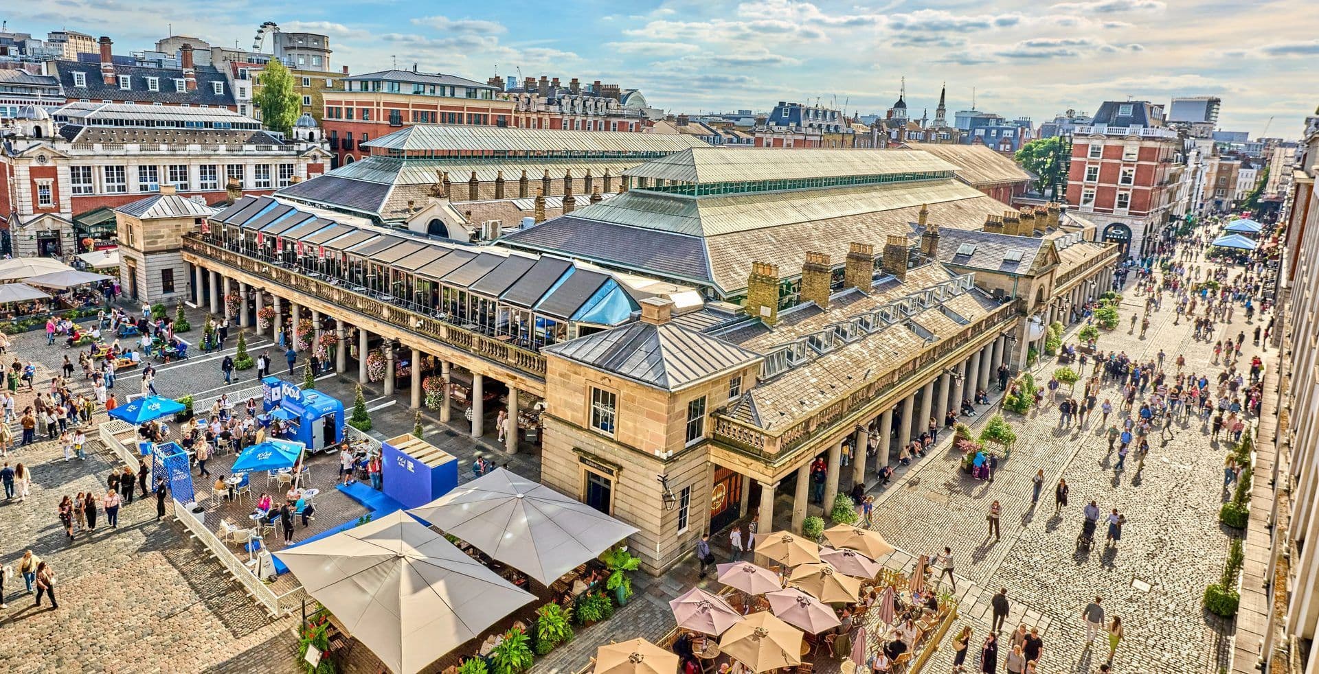 Aerial view of Covent Garden Market in London, a historic outdoor event space bustling with people and cafes.