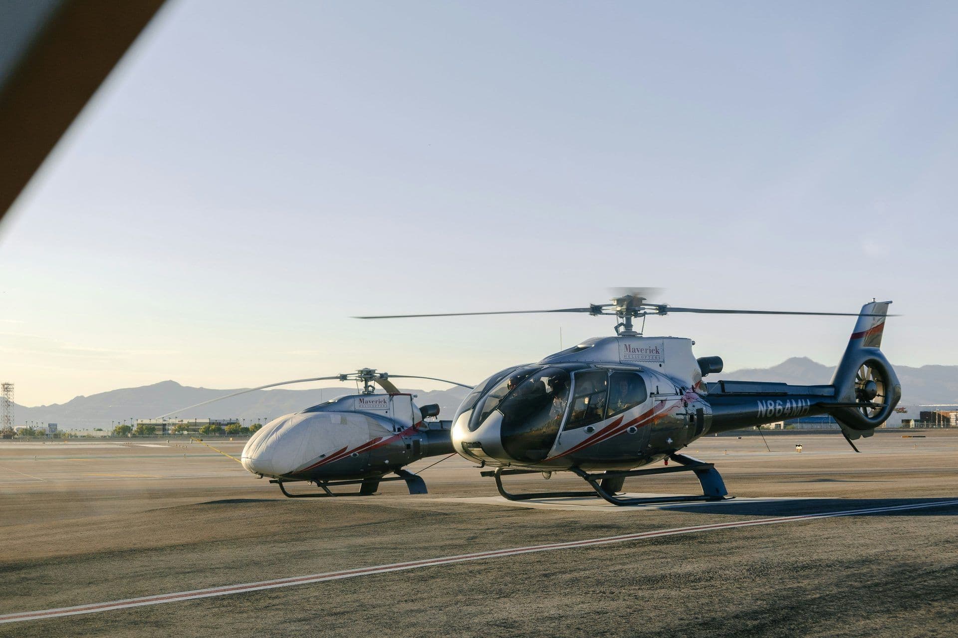 Two Maverick Helicopters on a Las Vegas airfield, one with spinning blades, for a corporate activity.